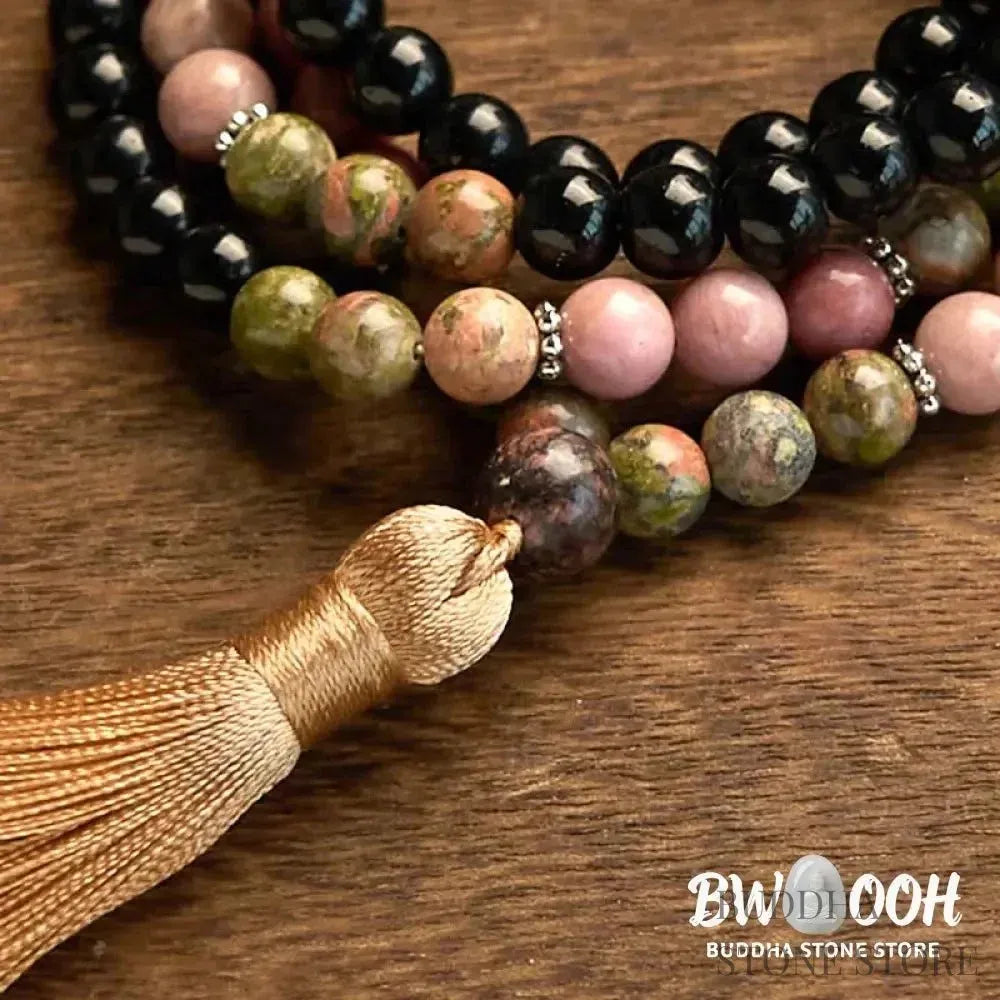 BWOOOH 108 Mala Beads crafted from Black Jasper and Rhodonite with a khaki tassel, resting on a meditation cushion, symbolizing grounding and emotional healing. - View 8