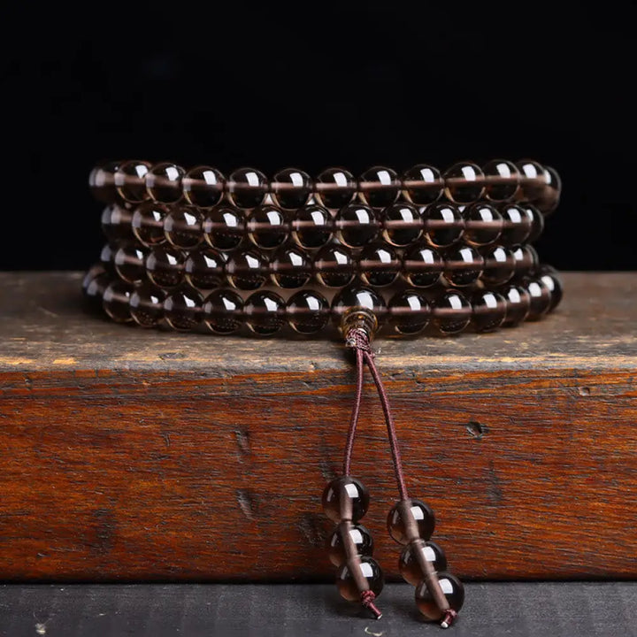 BWOOOH 108 Mala Beads crafted from polished Black Obsidian and shimmering Ice Obsidian, symbolizing energy protection and inner fulfillment, designed for meditation and mindfulness, photographed on a serene, textured surface. - View 13