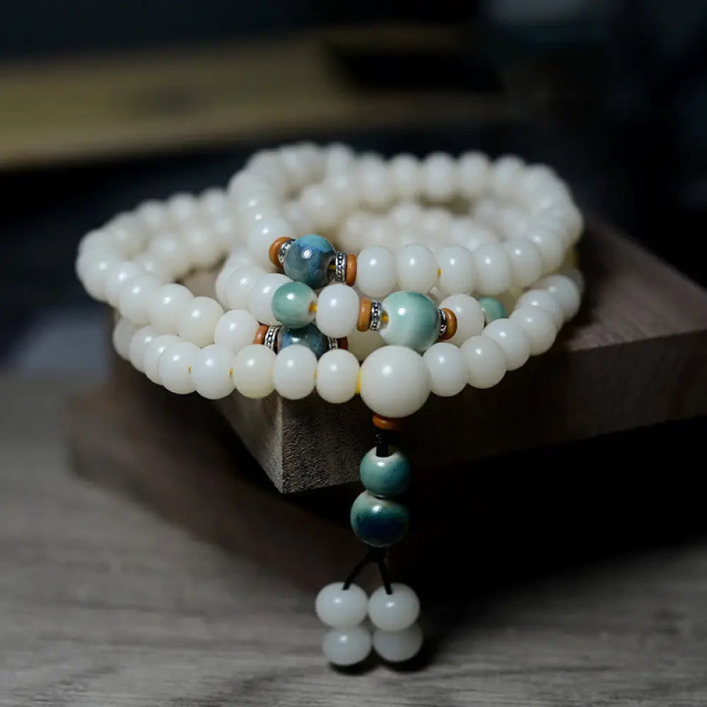 Close-up of BWOOOH 108 Bodhi Seed Mala beads, dark-speckled, strung on premium elastic, symbolizing wisdom, protection, and deep calm for meditation.