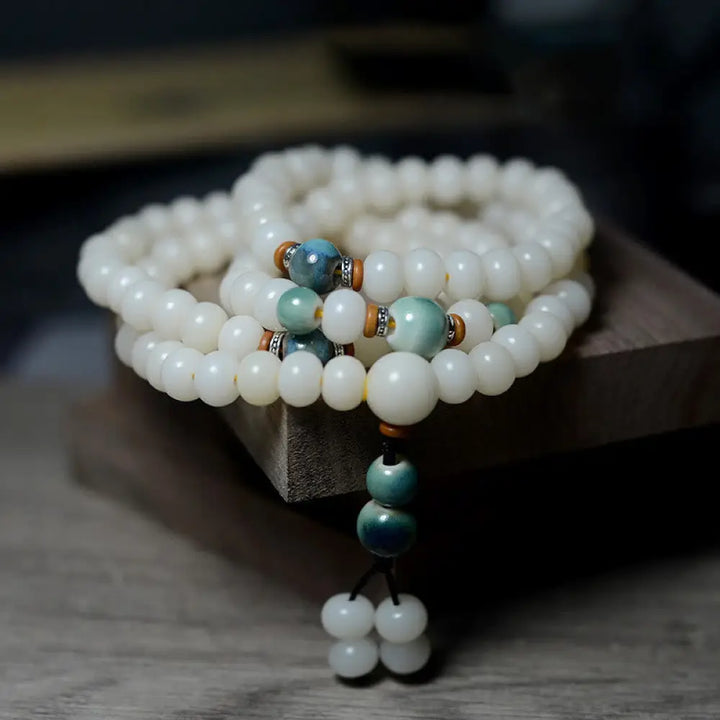Close-up of BWOOOH 108 Bodhi Seed Mala beads, dark-speckled, strung on premium elastic, symbolizing wisdom, protection, and deep calm for meditation.