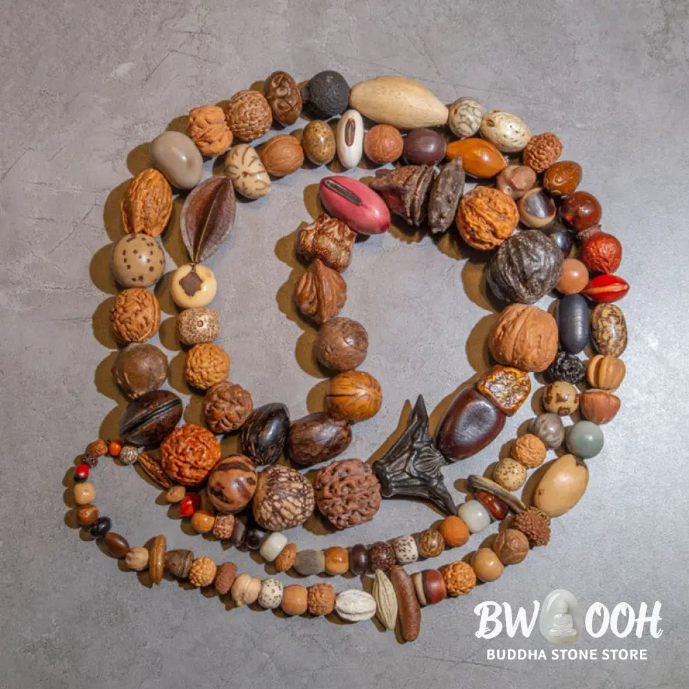 A close-up of the BWOOOH 108 Bodhi Seed Mala Bracelet, showcasing naturally varied seeds, a prominent guru bead, and a delicate lotus tassel, arranged for meditation or wrist wear. - View 2