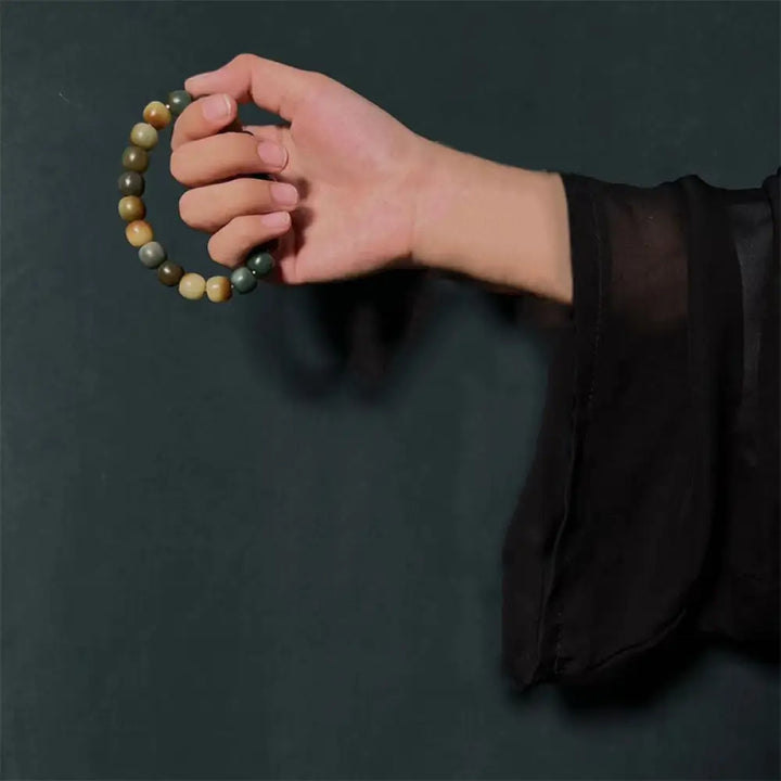 BWOOOH 108-bead Bodhi Seed Peace Wisdom Mala bracelet, showcasing dark-speckled bodhi seeds and small leaf red sandalwood accents, designed as a wrist or pocket mala for meditation and spiritual enlightenment. - View 4