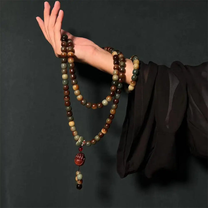 BWOOOH 108-bead Bodhi Seed Peace Wisdom Mala bracelet, showcasing dark-speckled bodhi seeds and small leaf red sandalwood accents, designed as a wrist or pocket mala for meditation and spiritual enlightenment.