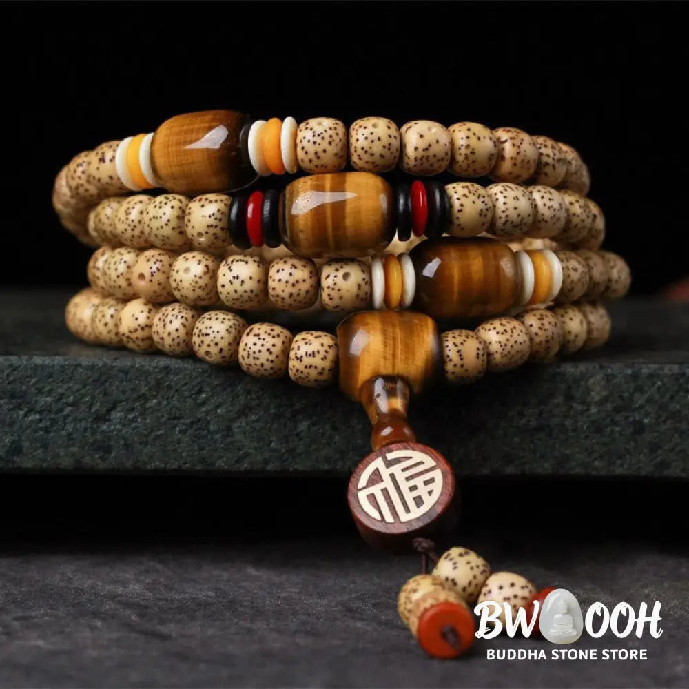 BWOOOH 108 Mala Beads Bodhi Seed & Tiger's Eye bracelet, featuring the auspicious Fu character, on a serene meditation mat, emphasizing spiritual peace and growth. - View 2