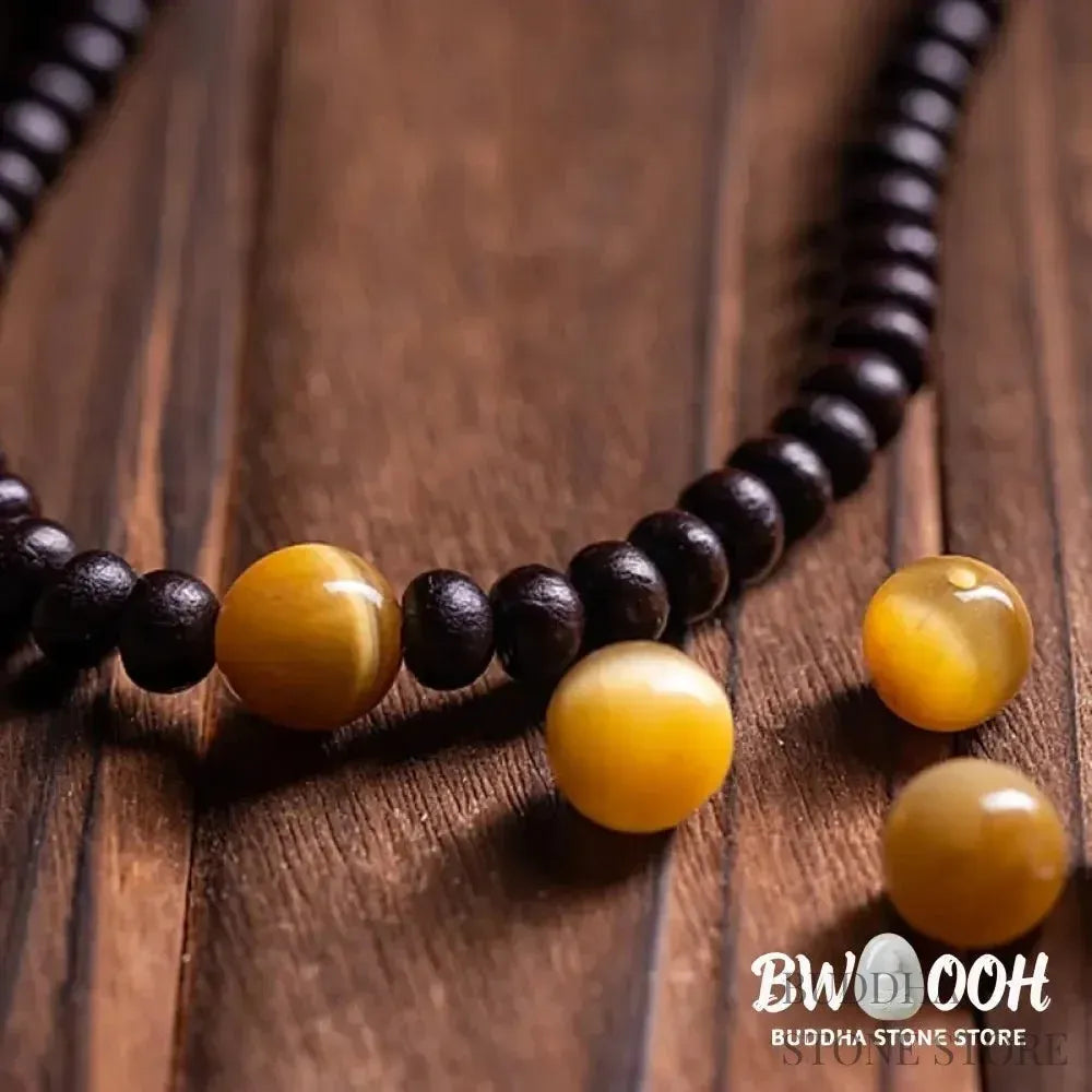 A close-up of the BWOOOH 108 Mala Bracelet, showcasing polished red Bowl Bodhi seeds, each with a distinct &