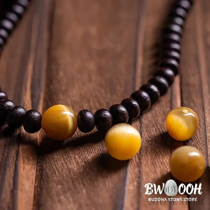 A close-up of the BWOOOH 108 Mala Bracelet, showcasing polished red Bowl Bodhi seeds, each with a distinct &