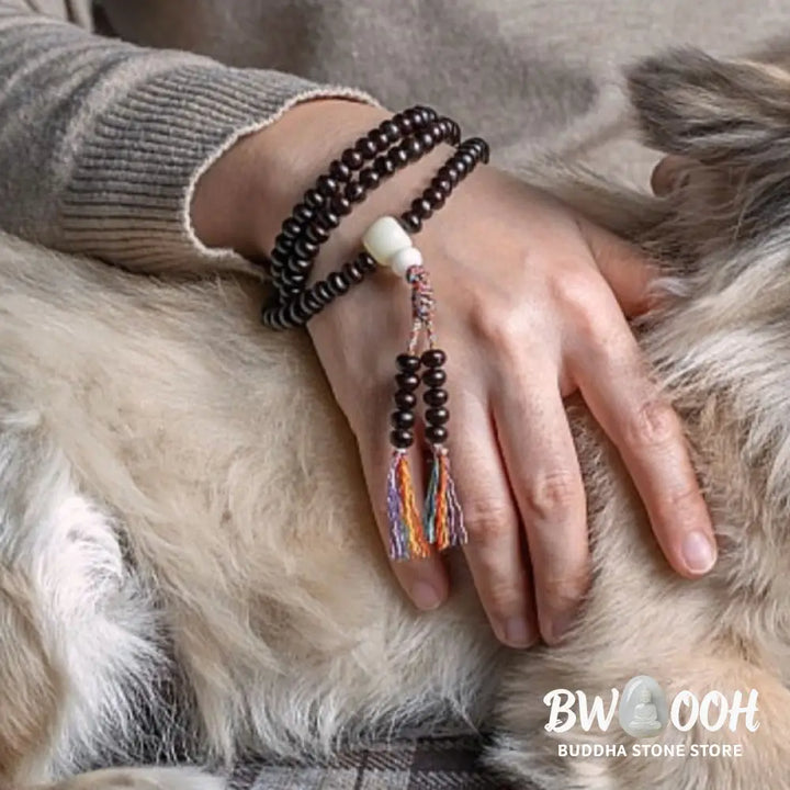 A close-up of the BWOOOH 108 Mala Bracelet, showcasing polished red Bowl Bodhi seeds, each with a distinct &