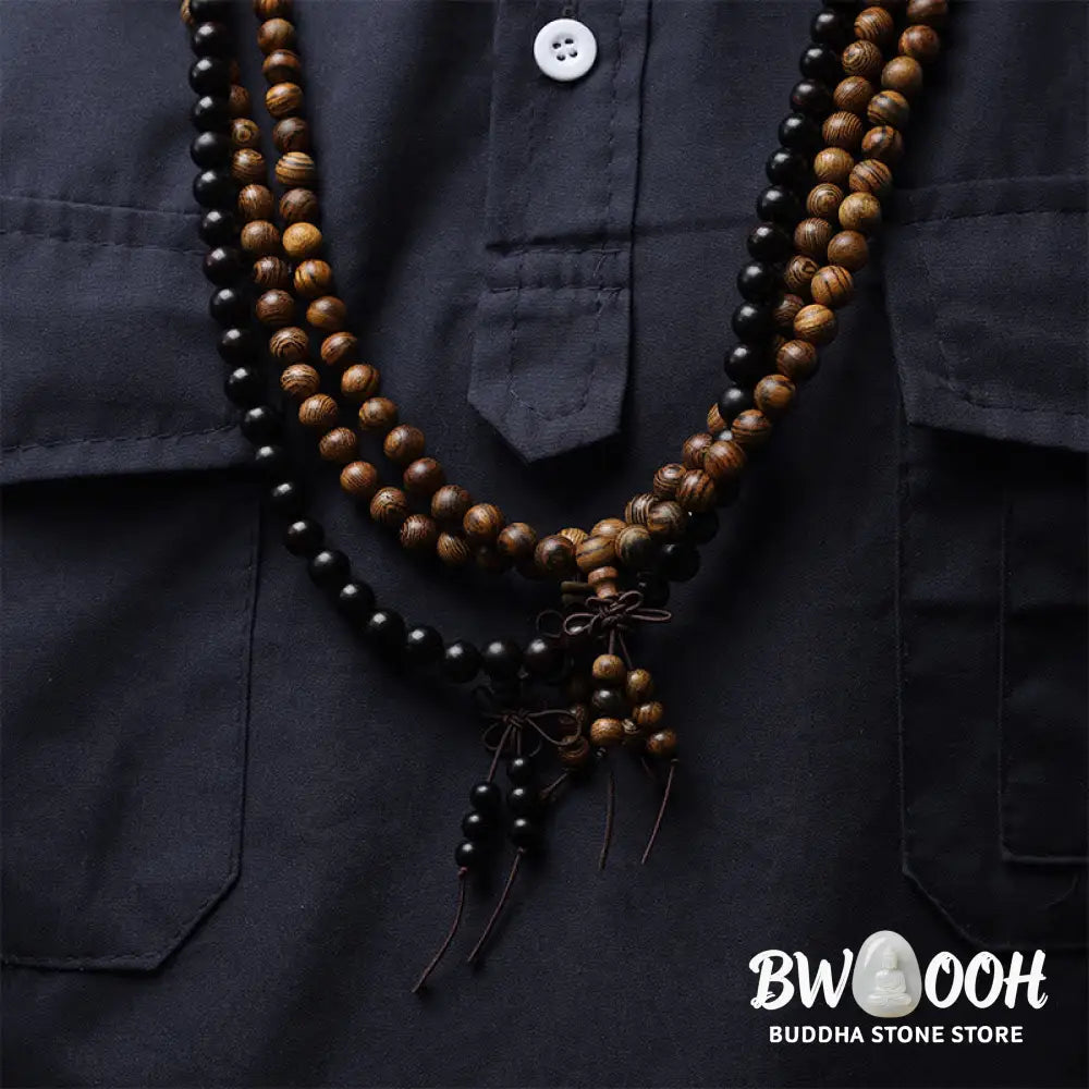 A close-up of the BWOOOH 108 mala beads bracelet, showcasing smooth, aromatic sandalwood interspersed with dark ebony, rich rosewood, and stabilizing wenge wood. The elastic design highlights the natural wood grain, perfect for meditation, prayer, and achieving daily spiritual balance. - View 5