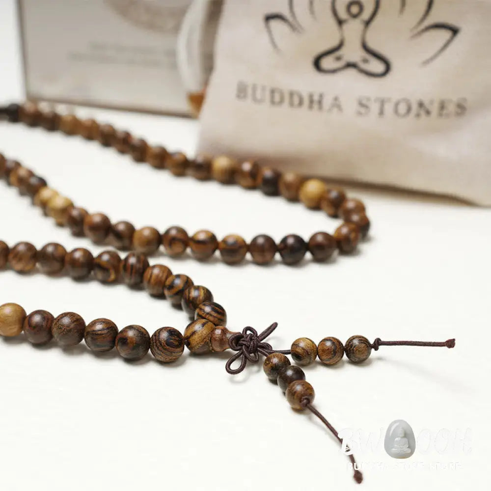 A close-up of the BWOOOH 108 mala beads bracelet, showcasing smooth, aromatic sandalwood interspersed with dark ebony, rich rosewood, and stabilizing wenge wood. The elastic design highlights the natural wood grain, perfect for meditation, prayer, and achieving daily spiritual balance. - View 24