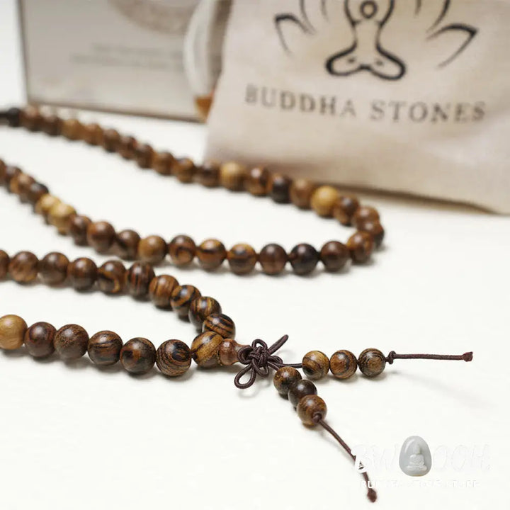 A close-up of the BWOOOH 108 mala beads bracelet, showcasing smooth, aromatic sandalwood interspersed with dark ebony, rich rosewood, and stabilizing wenge wood. The elastic design highlights the natural wood grain, perfect for meditation, prayer, and achieving daily spiritual balance. - View 24