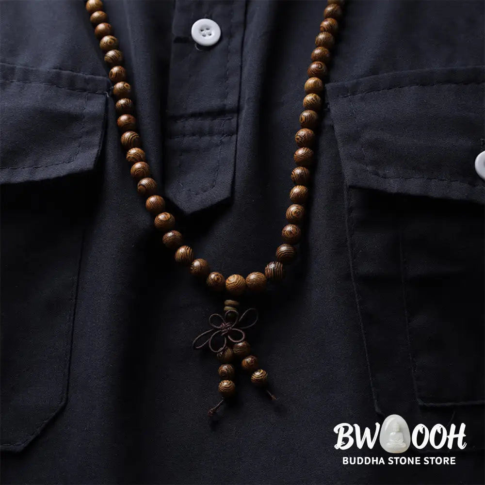 A close-up of the BWOOOH 108 mala beads bracelet, showcasing smooth, aromatic sandalwood interspersed with dark ebony, rich rosewood, and stabilizing wenge wood. The elastic design highlights the natural wood grain, perfect for meditation, prayer, and achieving daily spiritual balance. - View 16