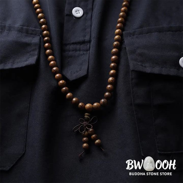 A close-up of the BWOOOH 108 mala beads bracelet, showcasing smooth, aromatic sandalwood interspersed with dark ebony, rich rosewood, and stabilizing wenge wood. The elastic design highlights the natural wood grain, perfect for meditation, prayer, and achieving daily spiritual balance. - View 16