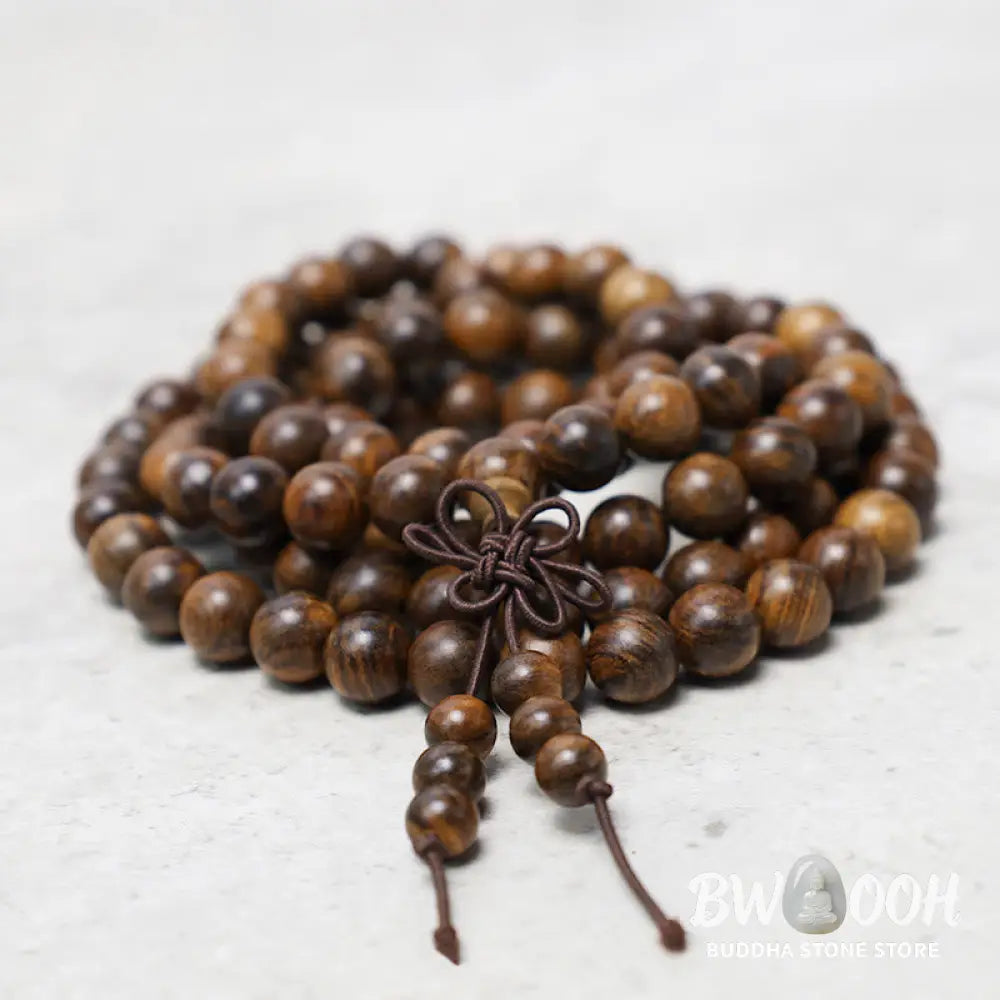 A close-up of the BWOOOH 108 mala beads bracelet, showcasing smooth, aromatic sandalwood interspersed with dark ebony, rich rosewood, and stabilizing wenge wood. The elastic design highlights the natural wood grain, perfect for meditation, prayer, and achieving daily spiritual balance. - View 2