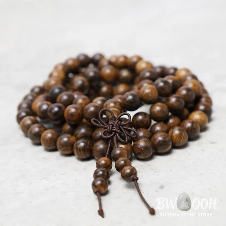 A close-up of the BWOOOH 108 mala beads bracelet, showcasing smooth, aromatic sandalwood interspersed with dark ebony, rich rosewood, and stabilizing wenge wood. The elastic design highlights the natural wood grain, perfect for meditation, prayer, and achieving daily spiritual balance. - View 2