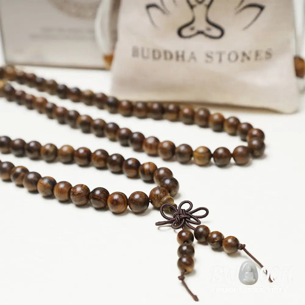 A close-up of the BWOOOH 108 mala beads bracelet, showcasing smooth, aromatic sandalwood interspersed with dark ebony, rich rosewood, and stabilizing wenge wood. The elastic design highlights the natural wood grain, perfect for meditation, prayer, and achieving daily spiritual balance. - View 6