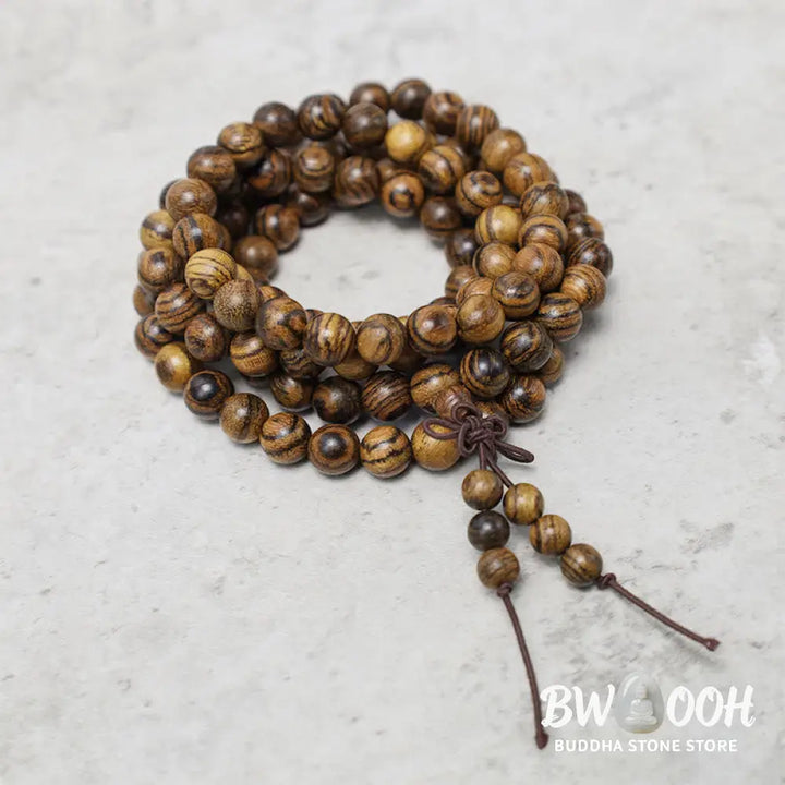 A close-up of the BWOOOH 108 mala beads bracelet, showcasing smooth, aromatic sandalwood interspersed with dark ebony, rich rosewood, and stabilizing wenge wood. The elastic design highlights the natural wood grain, perfect for meditation, prayer, and achieving daily spiritual balance. - View 22