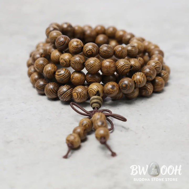 A close-up of the BWOOOH 108 mala beads bracelet, showcasing smooth, aromatic sandalwood interspersed with dark ebony, rich rosewood, and stabilizing wenge wood. The elastic design highlights the natural wood grain, perfect for meditation, prayer, and achieving daily spiritual balance. - View 17
