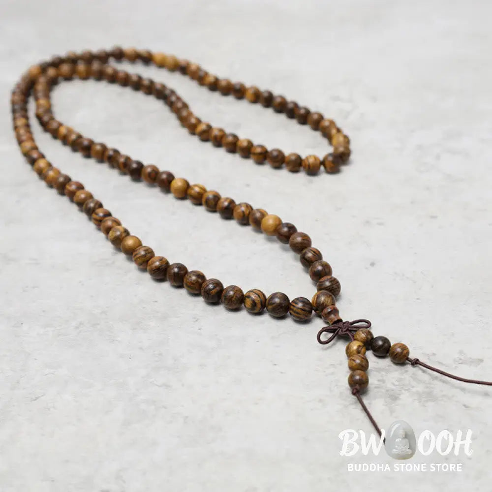 A close-up of the BWOOOH 108 mala beads bracelet, showcasing smooth, aromatic sandalwood interspersed with dark ebony, rich rosewood, and stabilizing wenge wood. The elastic design highlights the natural wood grain, perfect for meditation, prayer, and achieving daily spiritual balance. - View 23