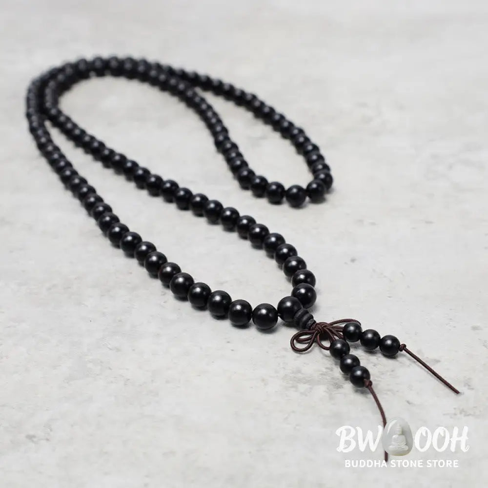 A close-up of the BWOOOH 108 mala beads bracelet, showcasing smooth, aromatic sandalwood interspersed with dark ebony, rich rosewood, and stabilizing wenge wood. The elastic design highlights the natural wood grain, perfect for meditation, prayer, and achieving daily spiritual balance. - View 11