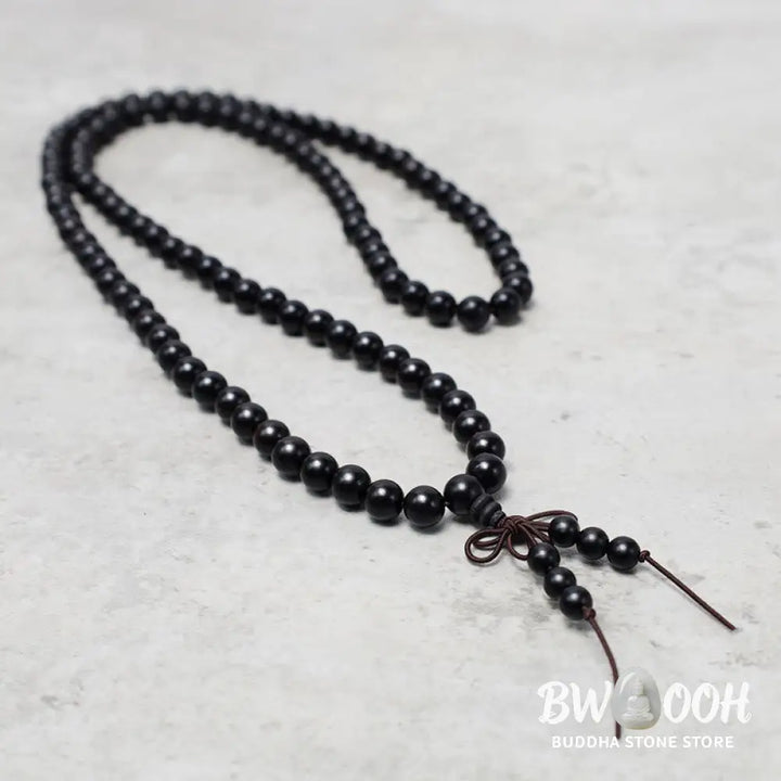 A close-up of the BWOOOH 108 mala beads bracelet, showcasing smooth, aromatic sandalwood interspersed with dark ebony, rich rosewood, and stabilizing wenge wood. The elastic design highlights the natural wood grain, perfect for meditation, prayer, and achieving daily spiritual balance. - View 11