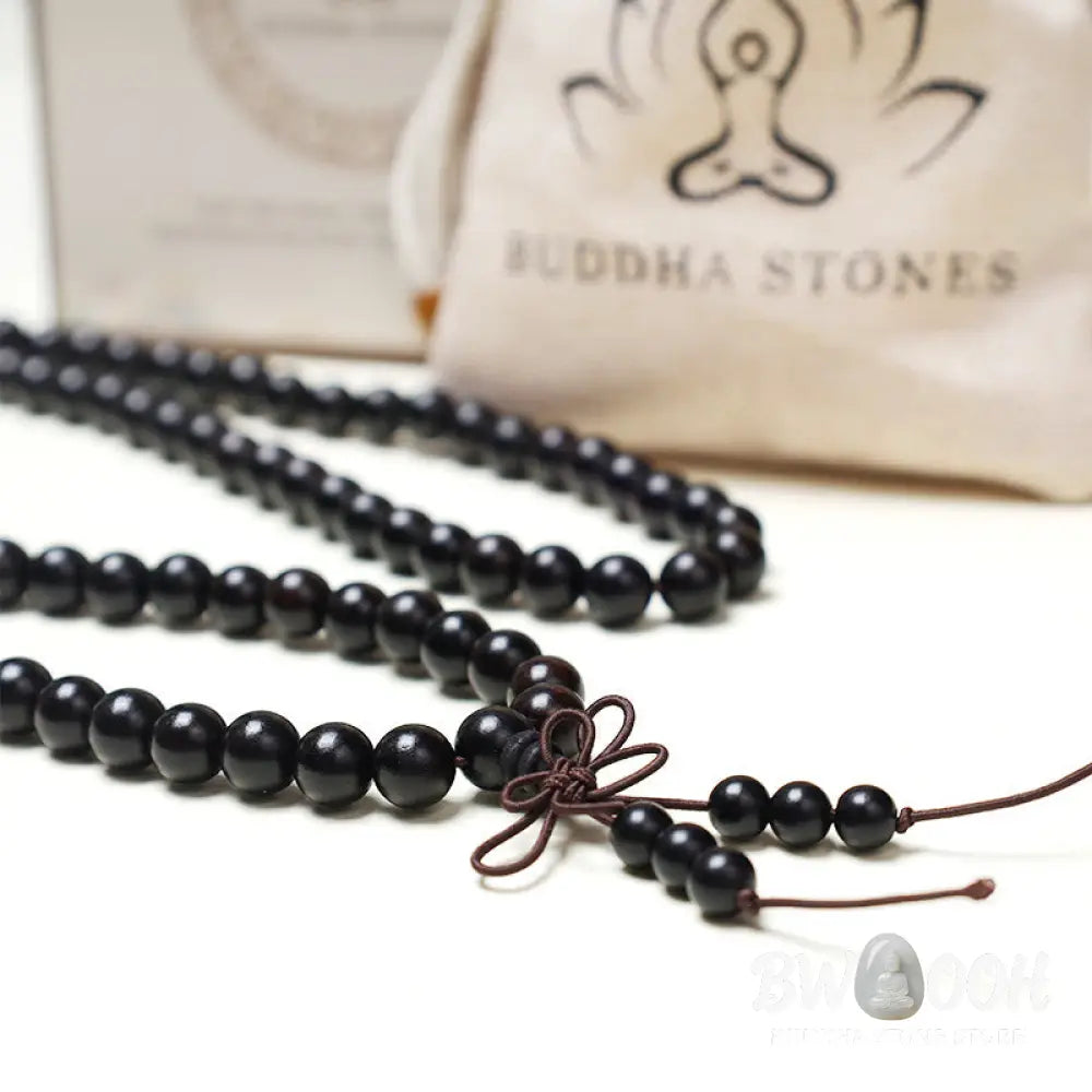 A close-up of the BWOOOH 108 mala beads bracelet, showcasing smooth, aromatic sandalwood interspersed with dark ebony, rich rosewood, and stabilizing wenge wood. The elastic design highlights the natural wood grain, perfect for meditation, prayer, and achieving daily spiritual balance. - View 12