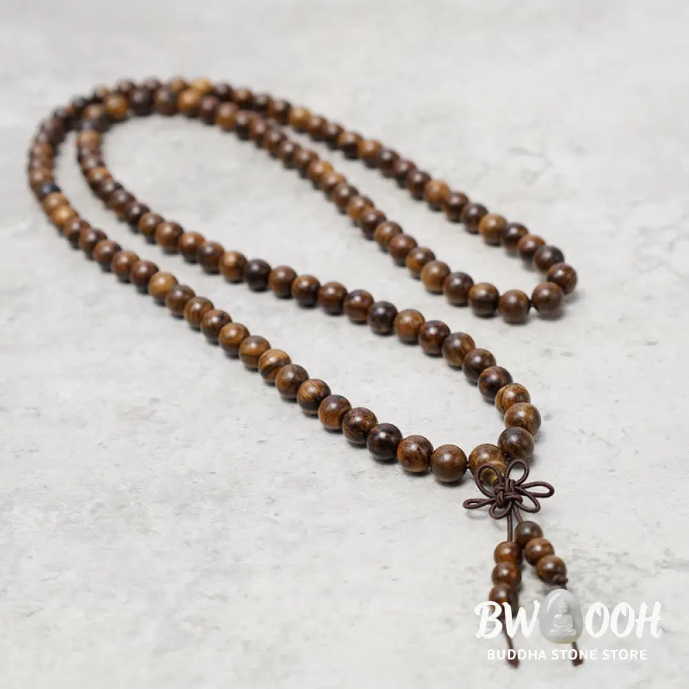 A close-up of the BWOOOH 108 mala beads bracelet, showcasing smooth, aromatic sandalwood interspersed with dark ebony, rich rosewood, and stabilizing wenge wood. The elastic design highlights the natural wood grain, perfect for meditation, prayer, and achieving daily spiritual balance. - View 4