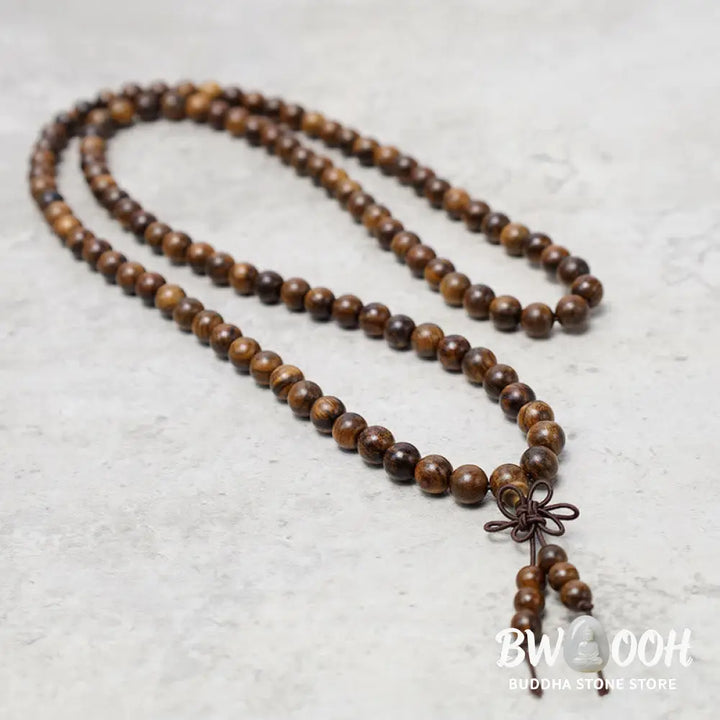 A close-up of the BWOOOH 108 mala beads bracelet, showcasing smooth, aromatic sandalwood interspersed with dark ebony, rich rosewood, and stabilizing wenge wood. The elastic design highlights the natural wood grain, perfect for meditation, prayer, and achieving daily spiritual balance. - View 4