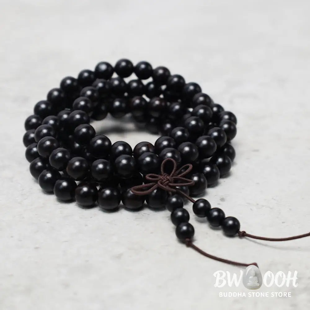 A close-up of the BWOOOH 108 mala beads bracelet, showcasing smooth, aromatic sandalwood interspersed with dark ebony, rich rosewood, and stabilizing wenge wood. The elastic design highlights the natural wood grain, perfect for meditation, prayer, and achieving daily spiritual balance. - View 9