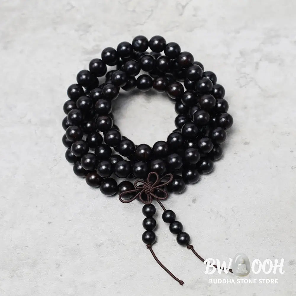 A close-up of the BWOOOH 108 mala beads bracelet, showcasing smooth, aromatic sandalwood interspersed with dark ebony, rich rosewood, and stabilizing wenge wood. The elastic design highlights the natural wood grain, perfect for meditation, prayer, and achieving daily spiritual balance. - View 10