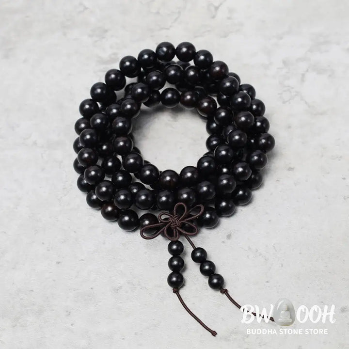 A close-up of the BWOOOH 108 mala beads bracelet, showcasing smooth, aromatic sandalwood interspersed with dark ebony, rich rosewood, and stabilizing wenge wood. The elastic design highlights the natural wood grain, perfect for meditation, prayer, and achieving daily spiritual balance. - View 10