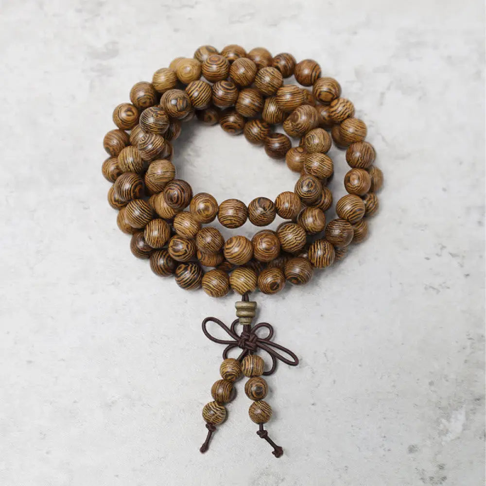 A close-up of the BWOOOH 108 mala beads bracelet, showcasing smooth, aromatic sandalwood interspersed with dark ebony, rich rosewood, and stabilizing wenge wood. The elastic design highlights the natural wood grain, perfect for meditation, prayer, and achieving daily spiritual balance. - View 14