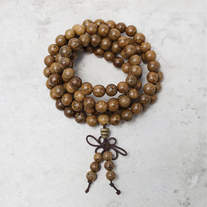 A close-up of the BWOOOH 108 mala beads bracelet, showcasing smooth, aromatic sandalwood interspersed with dark ebony, rich rosewood, and stabilizing wenge wood. The elastic design highlights the natural wood grain, perfect for meditation, prayer, and achieving daily spiritual balance. - View 14