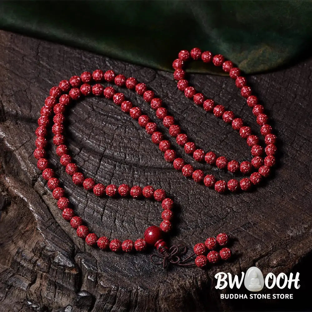 A BWOOOH Cinnabar 108 Mala Beads Blessing Bracelet, showcasing deeply engraved Om Mani Padme Hum mantra patterns on each bead, symbolizing spiritual protection and focus. - View 2