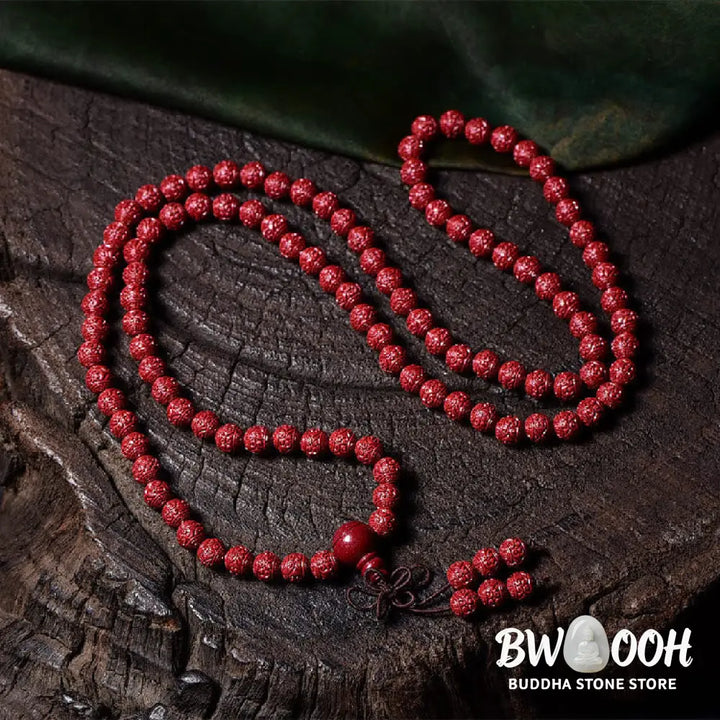 A BWOOOH Cinnabar 108 Mala Beads Blessing Bracelet, showcasing deeply engraved Om Mani Padme Hum mantra patterns on each bead, symbolizing spiritual protection and focus. - View 2