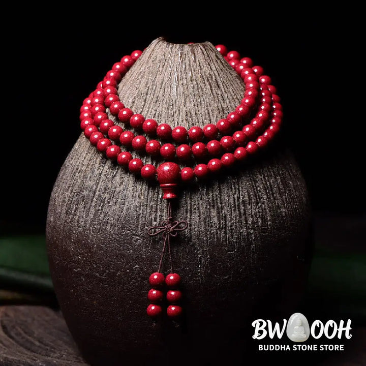 A BWOOOH Cinnabar 108 Mala Beads Blessing Bracelet, showcasing deeply engraved Om Mani Padme Hum mantra patterns on each bead, symbolizing spiritual protection and focus. - View 19