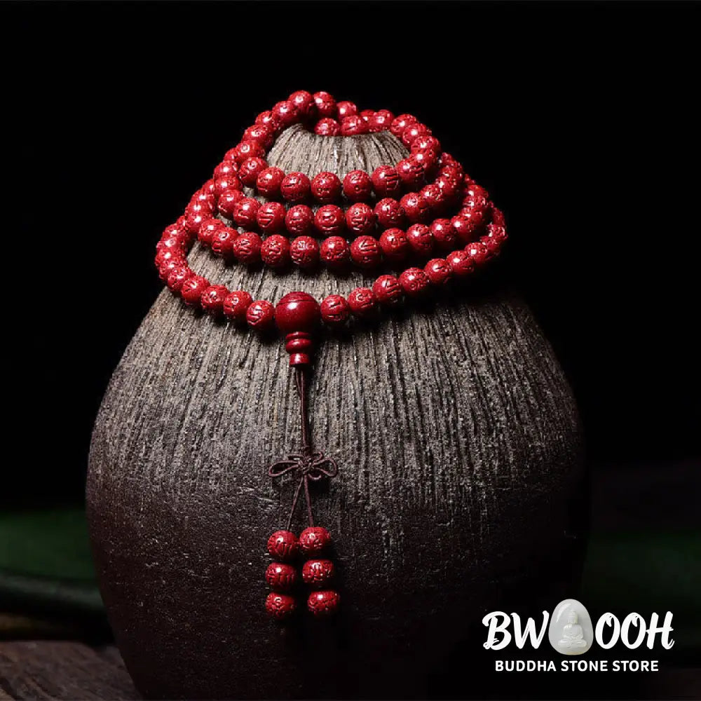 A BWOOOH Cinnabar 108 Mala Beads Blessing Bracelet, showcasing deeply engraved Om Mani Padme Hum mantra patterns on each bead, symbolizing spiritual protection and focus. - View 8