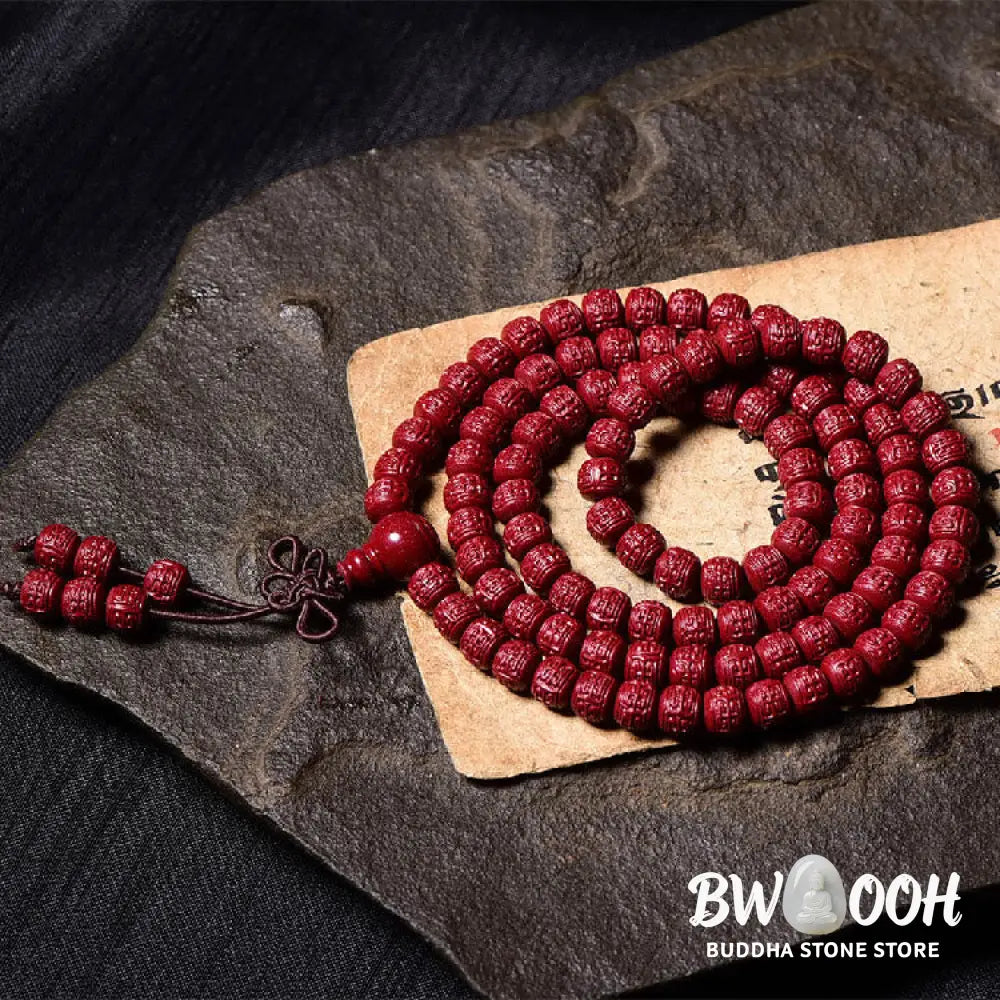 A BWOOOH Cinnabar 108 Mala Beads Blessing Bracelet, showcasing deeply engraved Om Mani Padme Hum mantra patterns on each bead, symbolizing spiritual protection and focus. - View 15