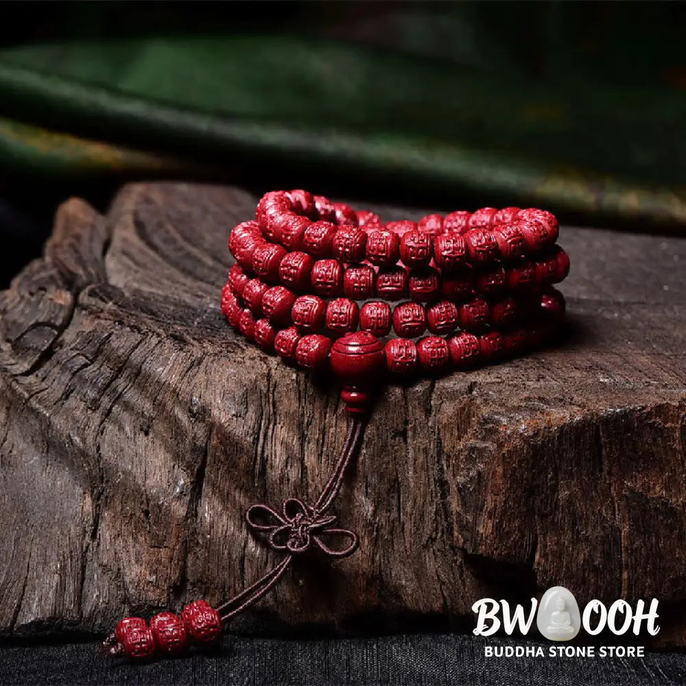 A BWOOOH Cinnabar 108 Mala Beads Blessing Bracelet, showcasing deeply engraved Om Mani Padme Hum mantra patterns on each bead, symbolizing spiritual protection and focus. - View 14