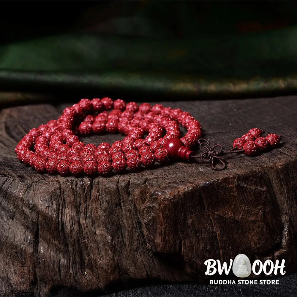 A BWOOOH Cinnabar 108 Mala Beads Blessing Bracelet, showcasing deeply engraved Om Mani Padme Hum mantra patterns on each bead, symbolizing spiritual protection and focus. - View 4
