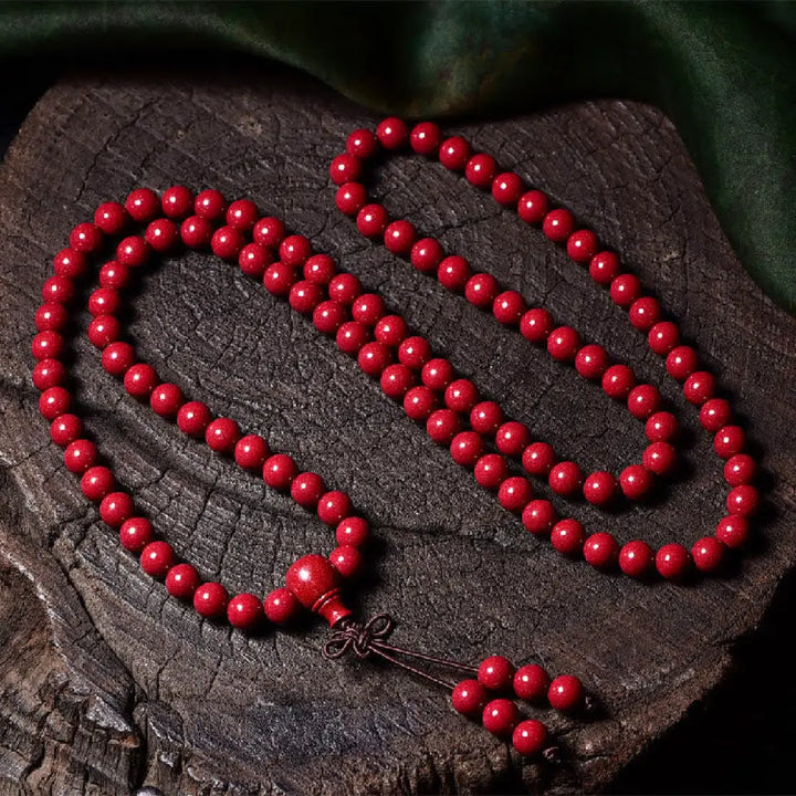 A BWOOOH Cinnabar 108 Mala Beads Blessing Bracelet, showcasing deeply engraved Om Mani Padme Hum mantra patterns on each bead, symbolizing spiritual protection and focus. - View 18