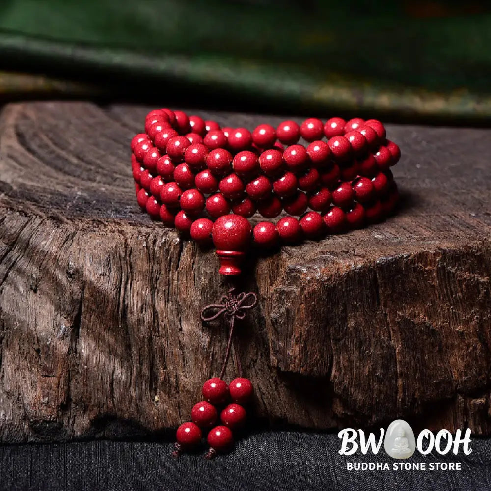 A BWOOOH Cinnabar 108 Mala Beads Blessing Bracelet, showcasing deeply engraved Om Mani Padme Hum mantra patterns on each bead, symbolizing spiritual protection and focus. - View 20