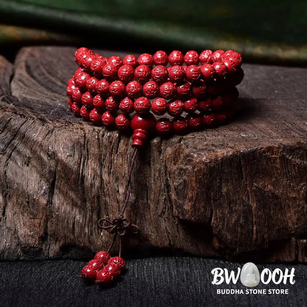 A BWOOOH Cinnabar 108 Mala Beads Blessing Bracelet, showcasing deeply engraved Om Mani Padme Hum mantra patterns on each bead, symbolizing spiritual protection and focus. - View 9
