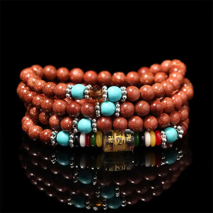 BWOOOH 108 Goldstone Mala Confidence Bracelet with Om Mani Padme Hum and Swastika symbols, promoting spiritual focus, balance, and positive energy during meditation.