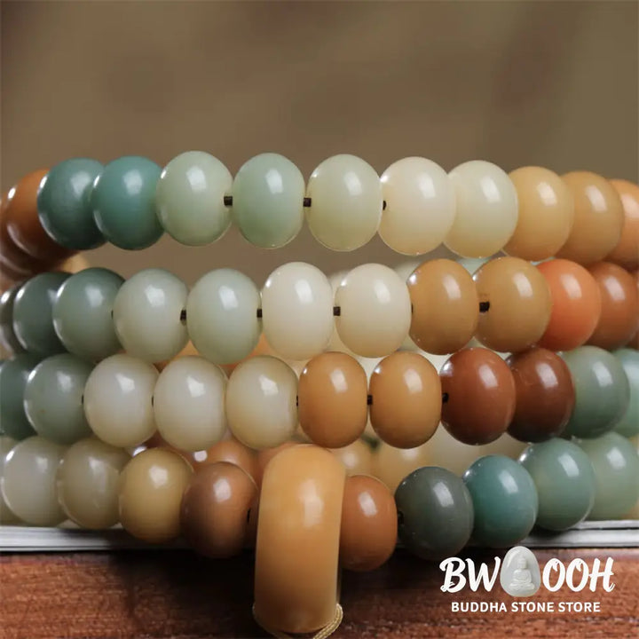 Close-up of BWOOOH 108 gradient Bodhi Seed mala beads, each hand-engraved with a subtle Buddha hand symbol, strung on an elastic peace bracelet, showcasing unique dark-speckled textures. - View 3