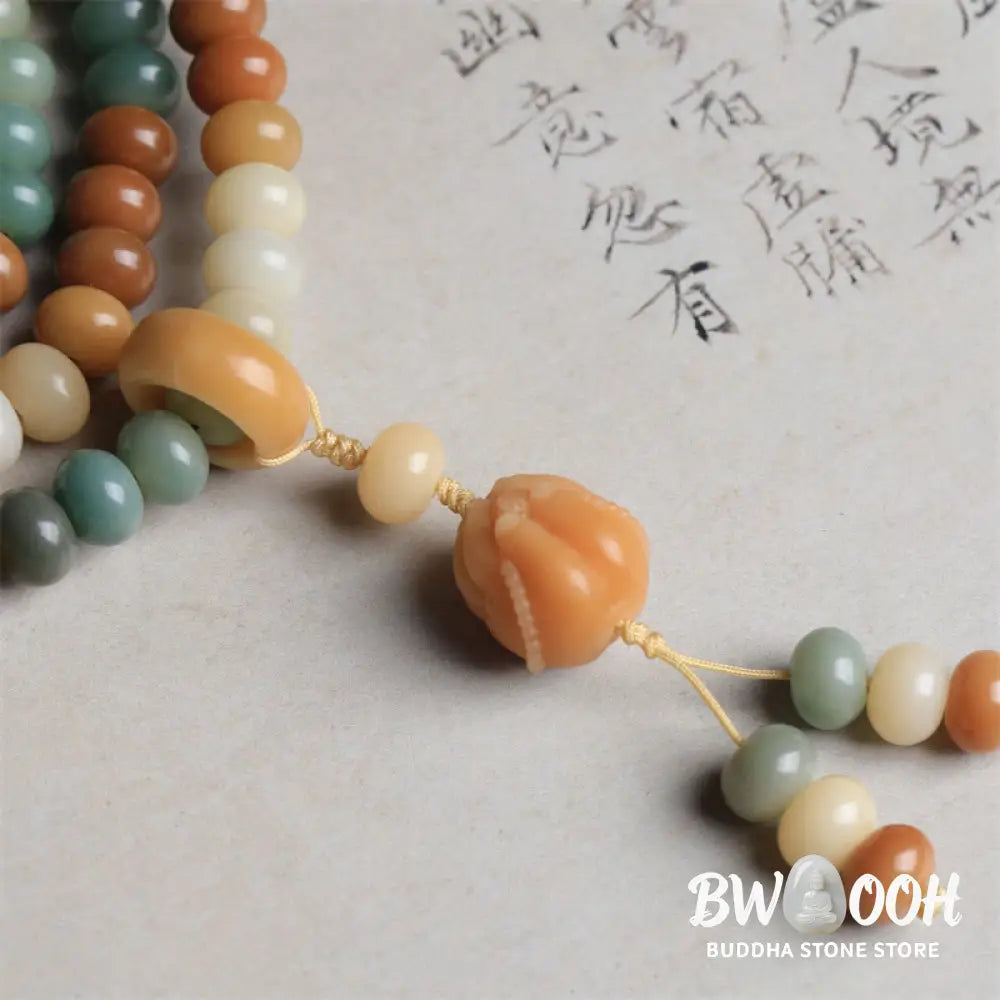 Close-up of BWOOOH 108 gradient Bodhi Seed mala beads, each hand-engraved with a subtle Buddha hand symbol, strung on an elastic peace bracelet, showcasing unique dark-speckled textures. - View 6