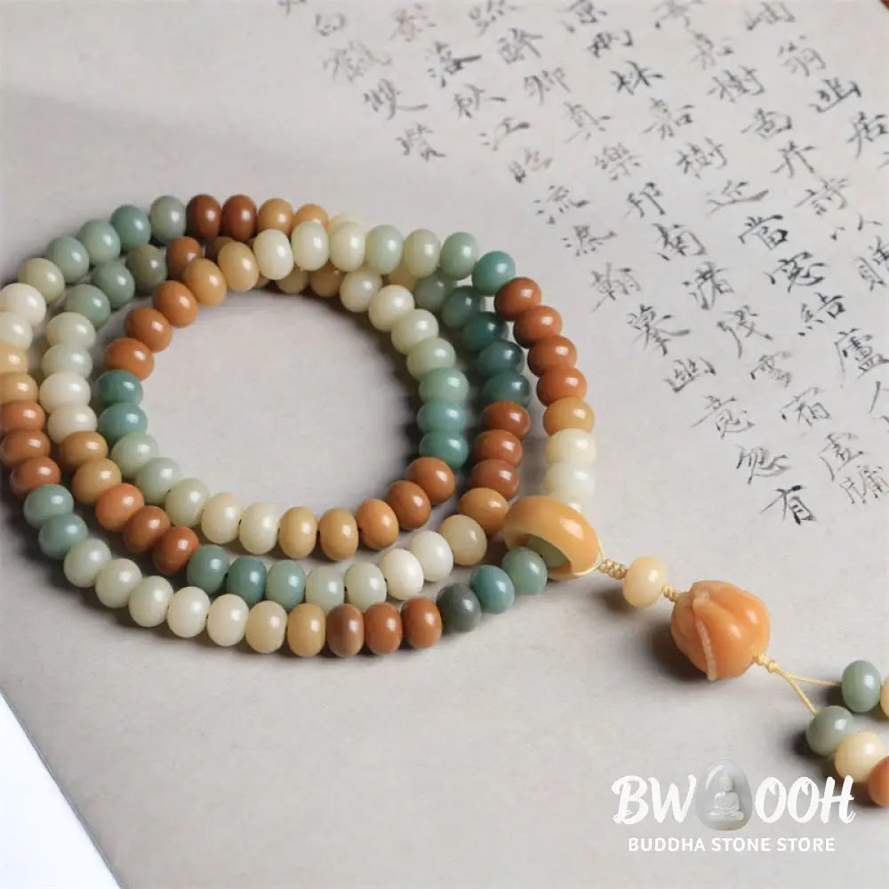 Close-up of BWOOOH 108 gradient Bodhi Seed mala beads, each hand-engraved with a subtle Buddha hand symbol, strung on an elastic peace bracelet, showcasing unique dark-speckled textures. - View 2
