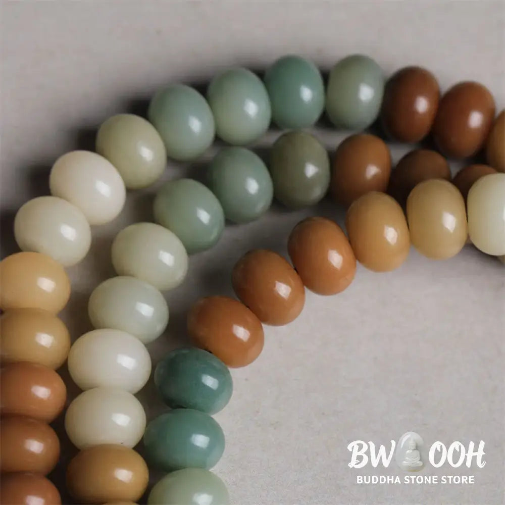 Close-up of BWOOOH 108 gradient Bodhi Seed mala beads, each hand-engraved with a subtle Buddha hand symbol, strung on an elastic peace bracelet, showcasing unique dark-speckled textures. - View 4