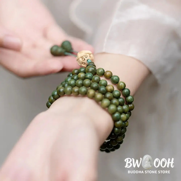 BWOOOH 108 mala beads bracelet crafted from natural green sandalwood and boxwood, featuring a distinct lotus symbol charm, designed for meditation, positive energy, and spiritual tranquility. - View 10