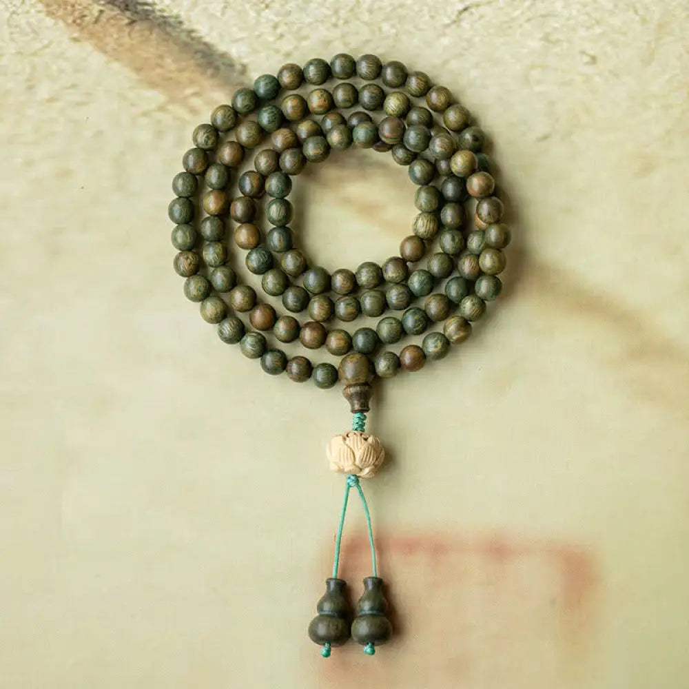 BWOOOH 108 mala beads bracelet crafted from natural green sandalwood and boxwood, featuring a distinct lotus symbol charm, designed for meditation, positive energy, and spiritual tranquility. - View 6