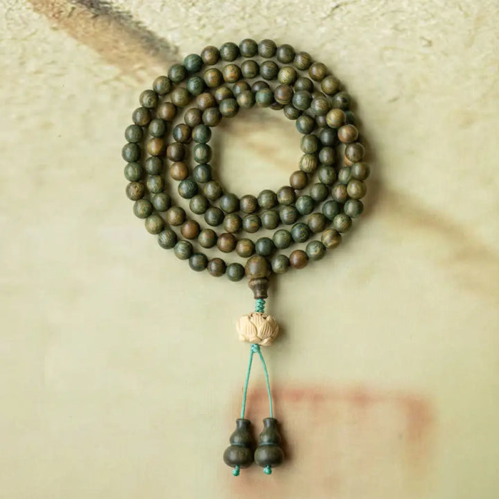 BWOOOH 108 mala beads bracelet crafted from natural green sandalwood and boxwood, featuring a distinct lotus symbol charm, designed for meditation, positive energy, and spiritual tranquility. - View 6